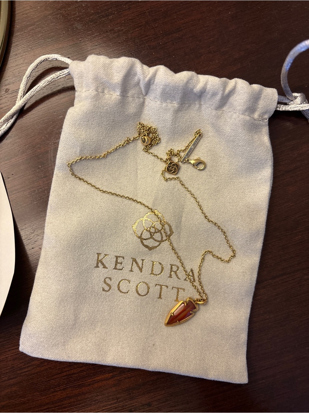 Kendra Scott Gold Necklace with Coral-Red Arrowhead Pendant